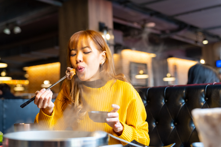 Asian woman eating asian food